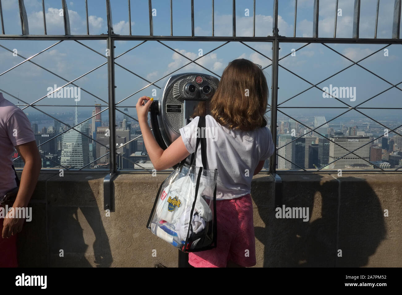 Young Girl at telescope at the Empire State Building, New York Stock Photo