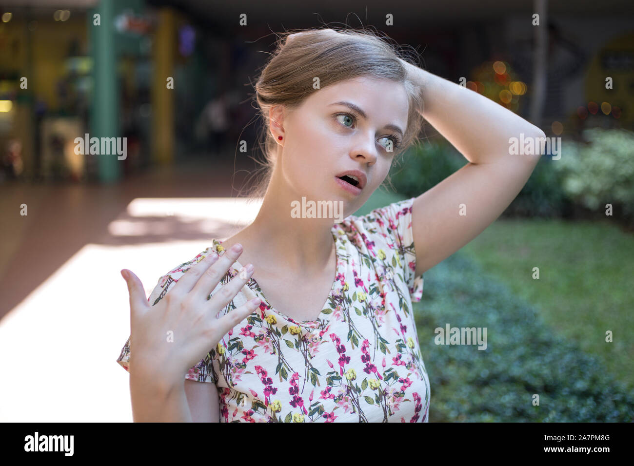 Young caucasian woman girl on a hot sunny day suffers from the heat stroke Stock Photo