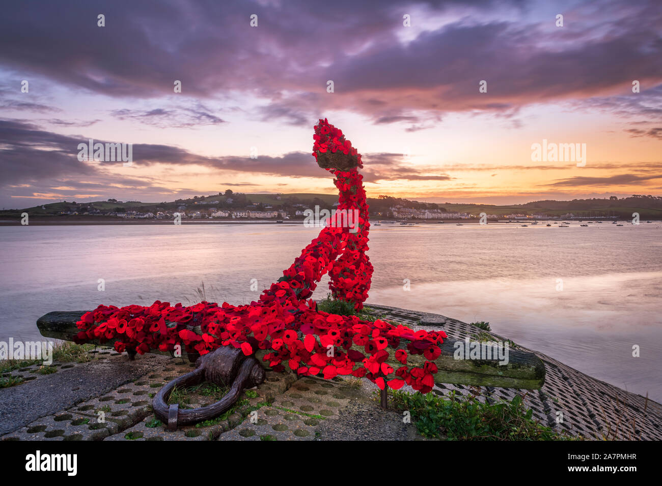 Appledore, North Devon, England. Monday 4th November 2019. UK Weather. Heavy cloud starts to build up just before sunrise as heavy showers are forecast for North Devon at the start of Remembrance week. The landmark anchor at Appledore has been covered by the local community with knitted poppies in preparation for the forthcoming Remembrance Sunday. Terry Mathews/Alamy Live News. Stock Photo