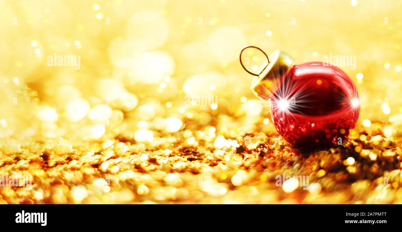 Christmas ball on abstract gold blur background. Stock Photo