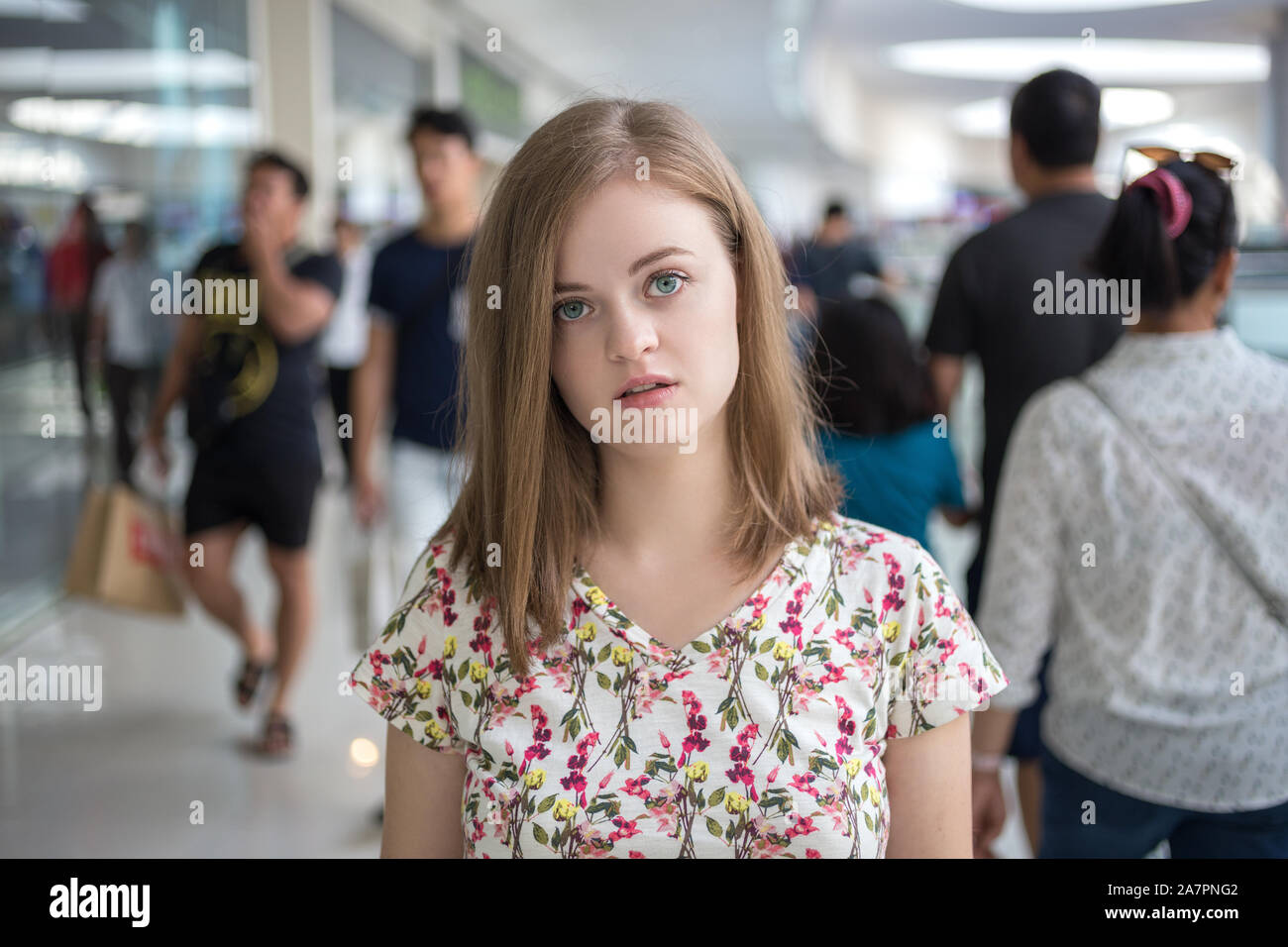 Young caucasian woman girl stand out from the crowd alone. Loneliness concept Stock Photo