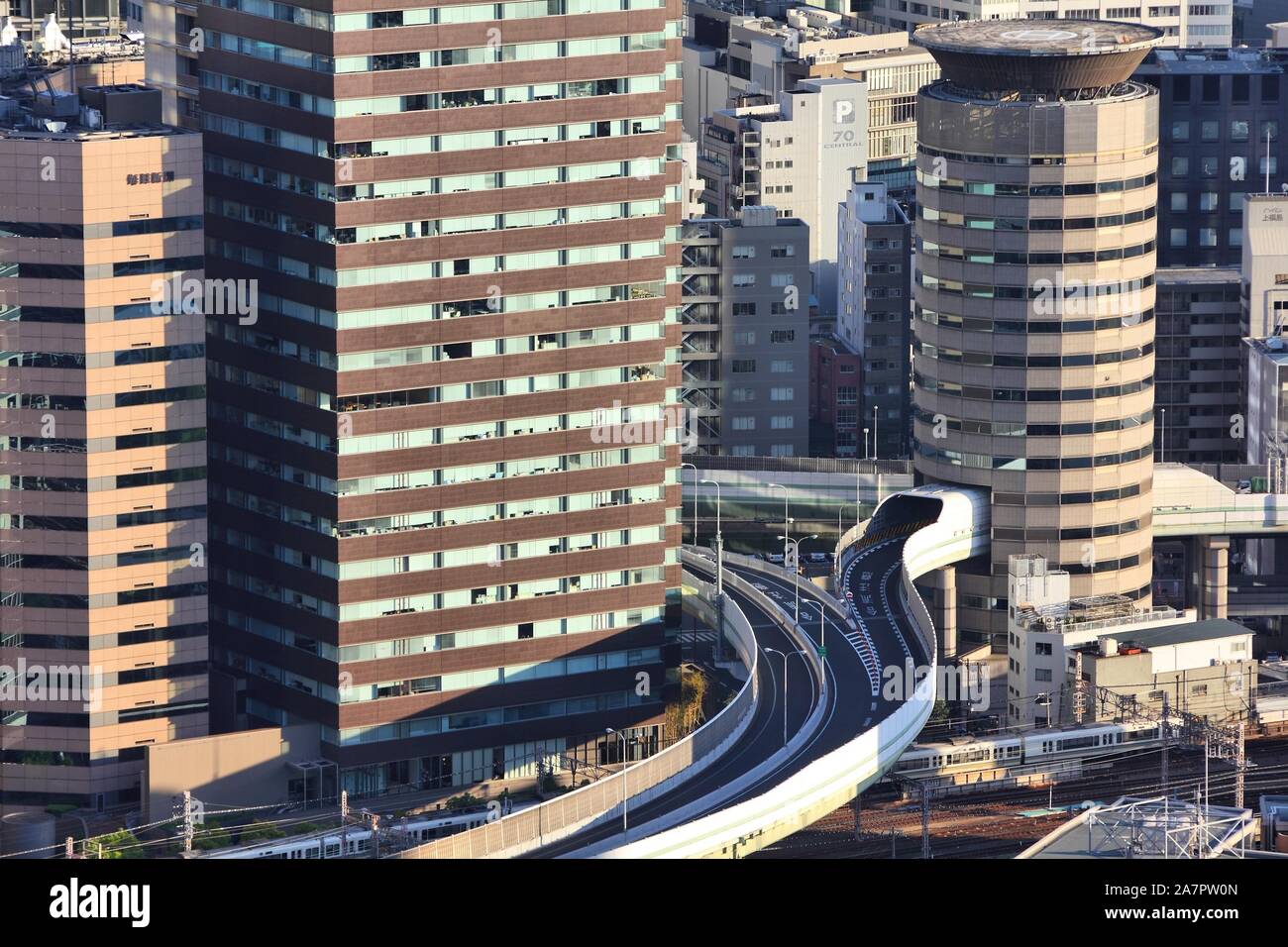 OSAKA, JAPAN - APRIL 27, 2012: Road goes through Gate Tower Building in Osaka, Japan. The building is extremely popular because of highway crossing th Stock Photo