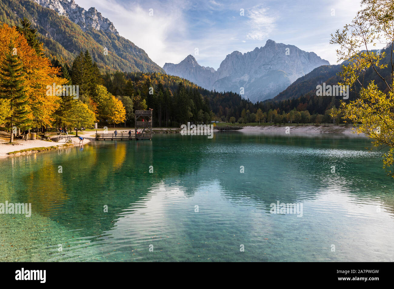 Jasna lake in Kranjsna gora, Prisojnik and Razor moutain peaks in the background Stock Photo