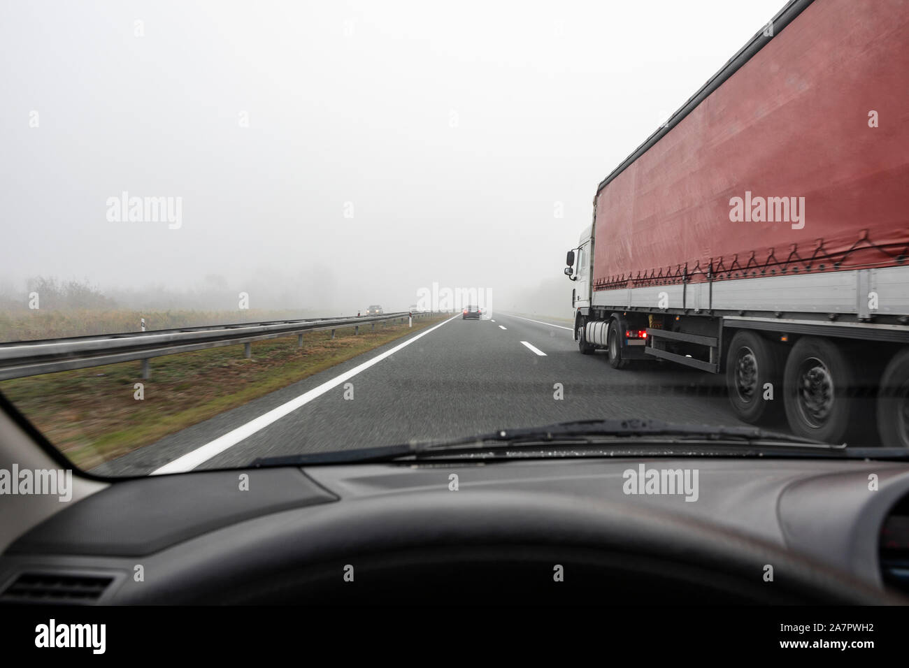 Overtaking truck on the highway in bad visbility Stock Photo
