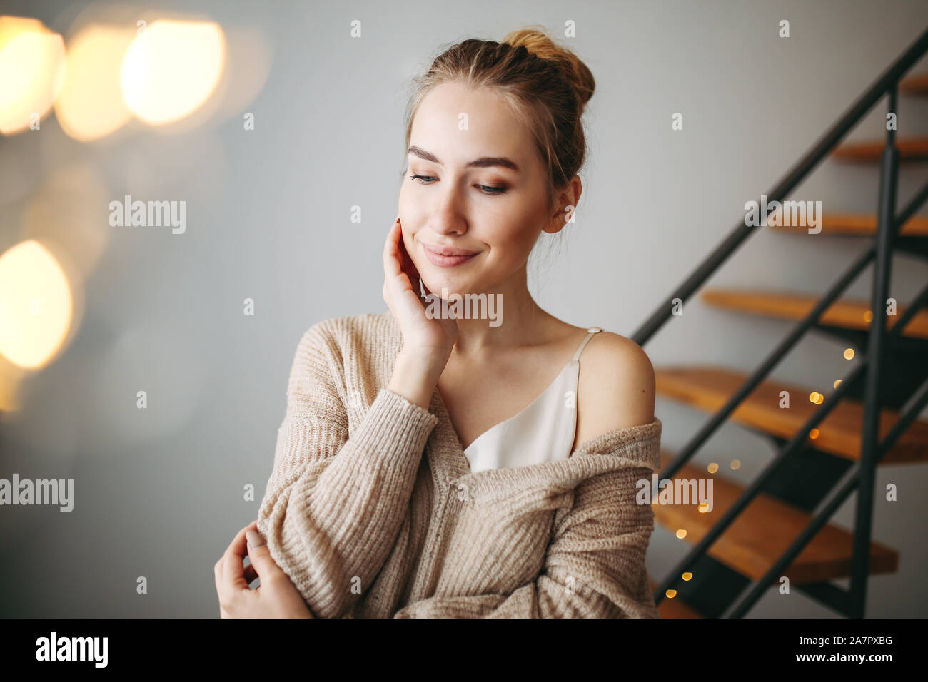 Young Beautiful Girl With Blonde Hair In Evening Beige Silk Dress