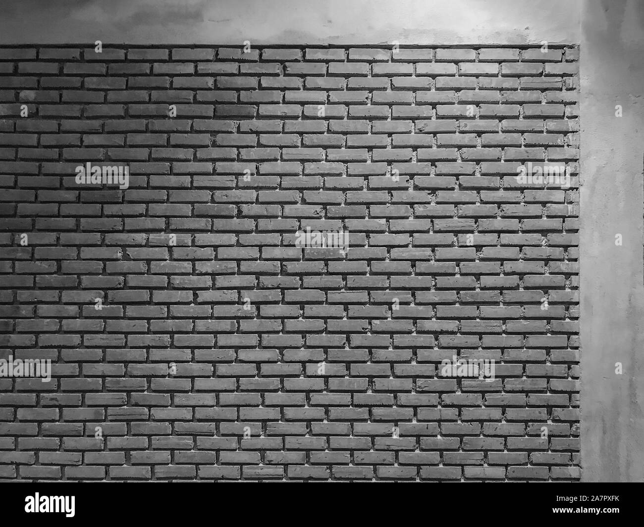 weathered old dark black cement brick blocks wall texture surface background. Stock Photo