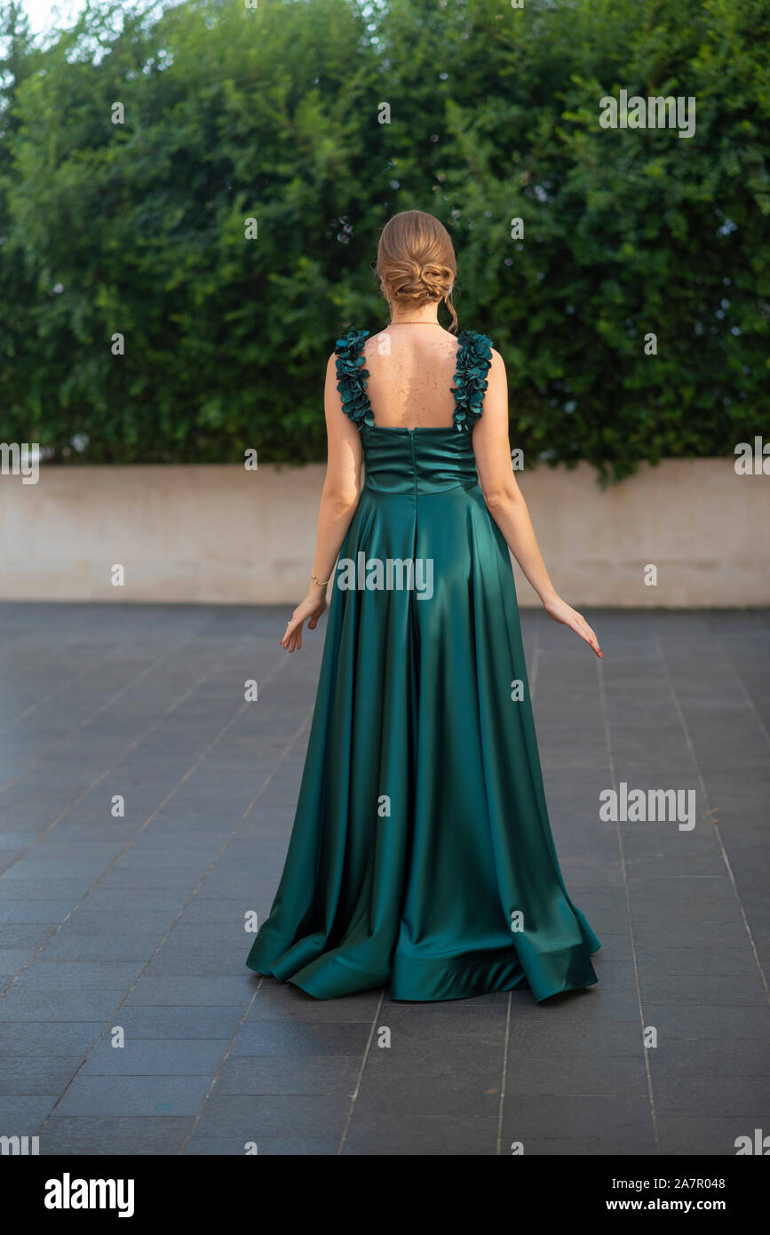 Full length woman wearing green evening gown Stock Photo