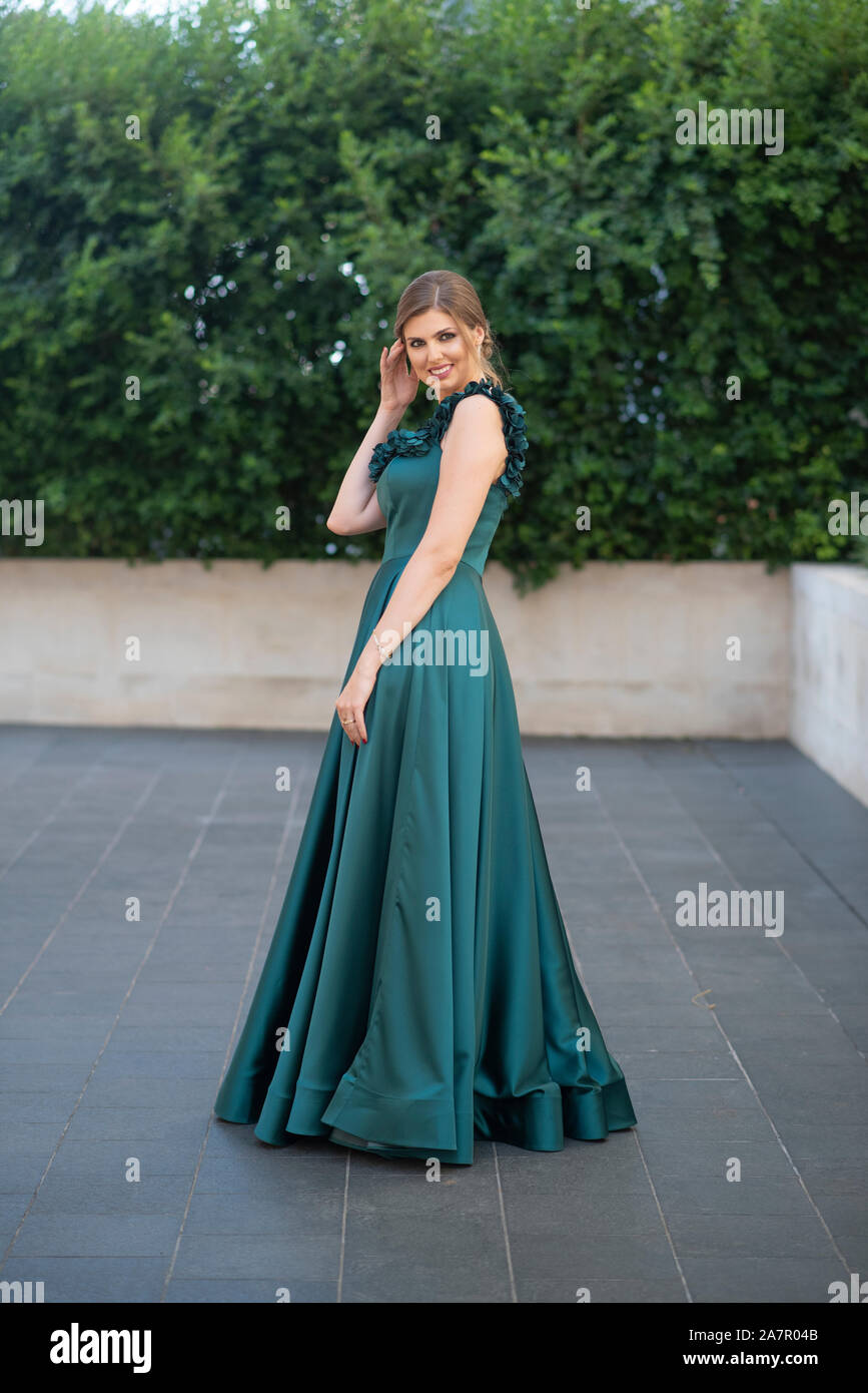 Full length woman wearing green evening gown Stock Photo