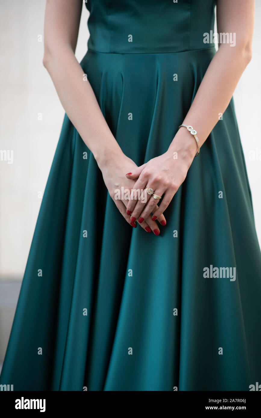 Close up of woman in green evening gown standing outdoors Stock Photo
