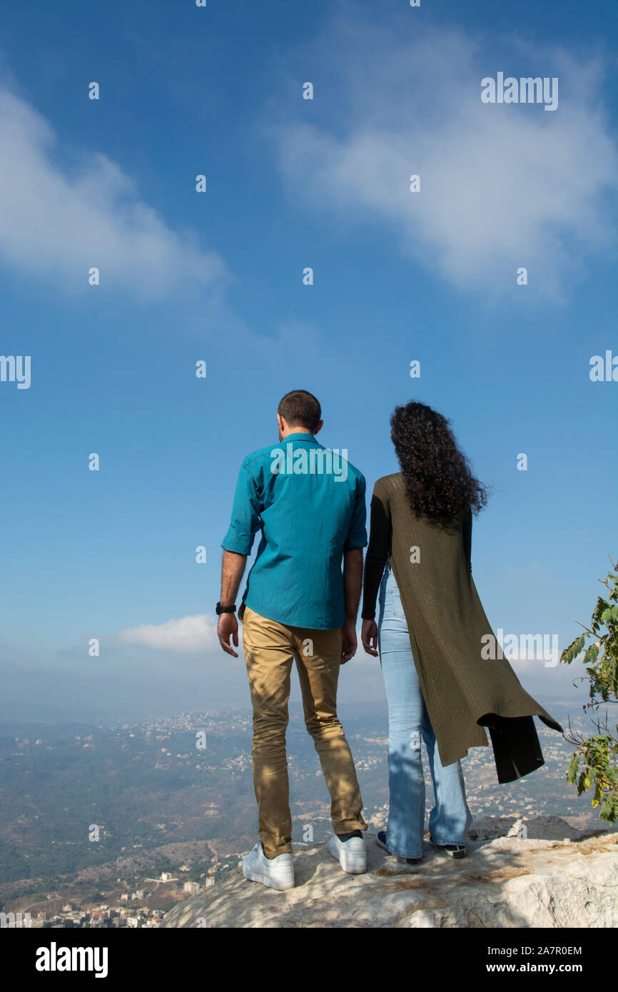 Rear view of man and woman standing outdoors Stock Photo