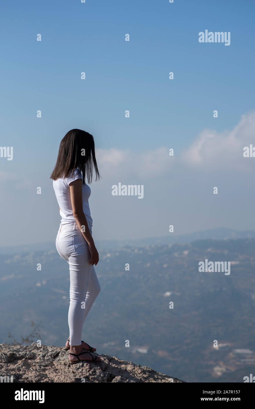 Rear view of young woman standing outdoors Stock Photo - Alamy