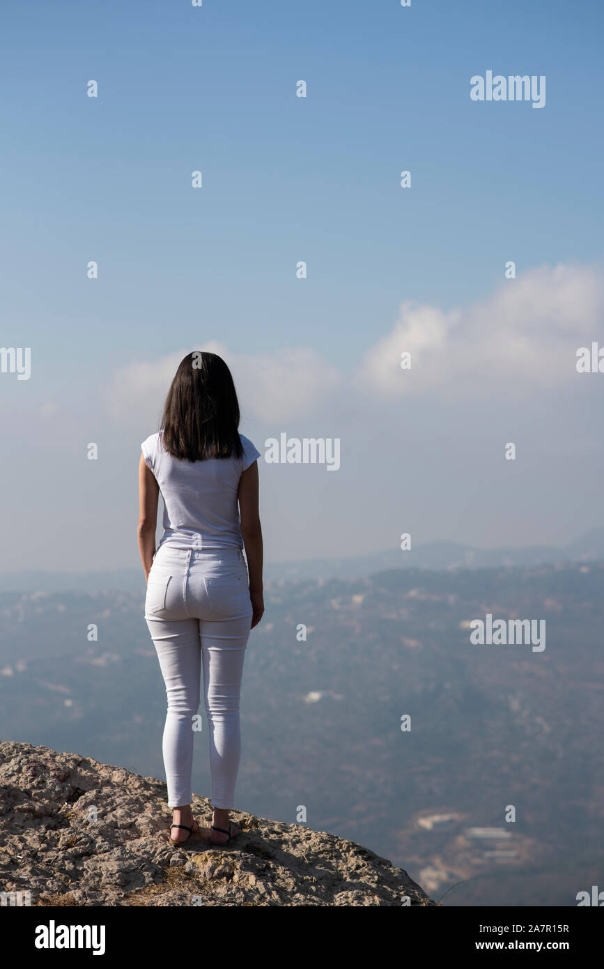Rear view of young woman standing outdoors Stock Photo - Alamy