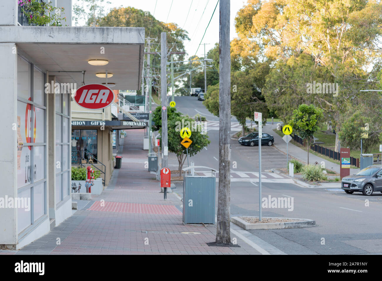 Early morning and the main shopping strip in Brighton Street Bundeena is empty of people, soon though the coffee shop will open and a crowd will form. Stock Photo