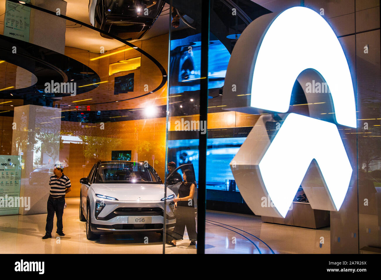 FILE--Customers shop at a dealership store of NIO in Shanghai, China, 11  August 2019. Chinese electric vehicle maker Nio Inc. will reduce its work f  Stock Photo - Alamy