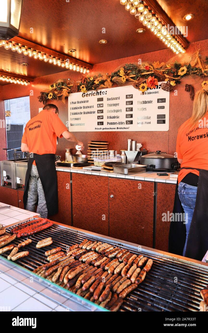 NUREMBERG, GERMANY - MAY 7, 2018: People work in a barbecue sausage stand in Nuremberg, Germany. Nuremberg city in Middle Franconia is famous for spec Stock Photo