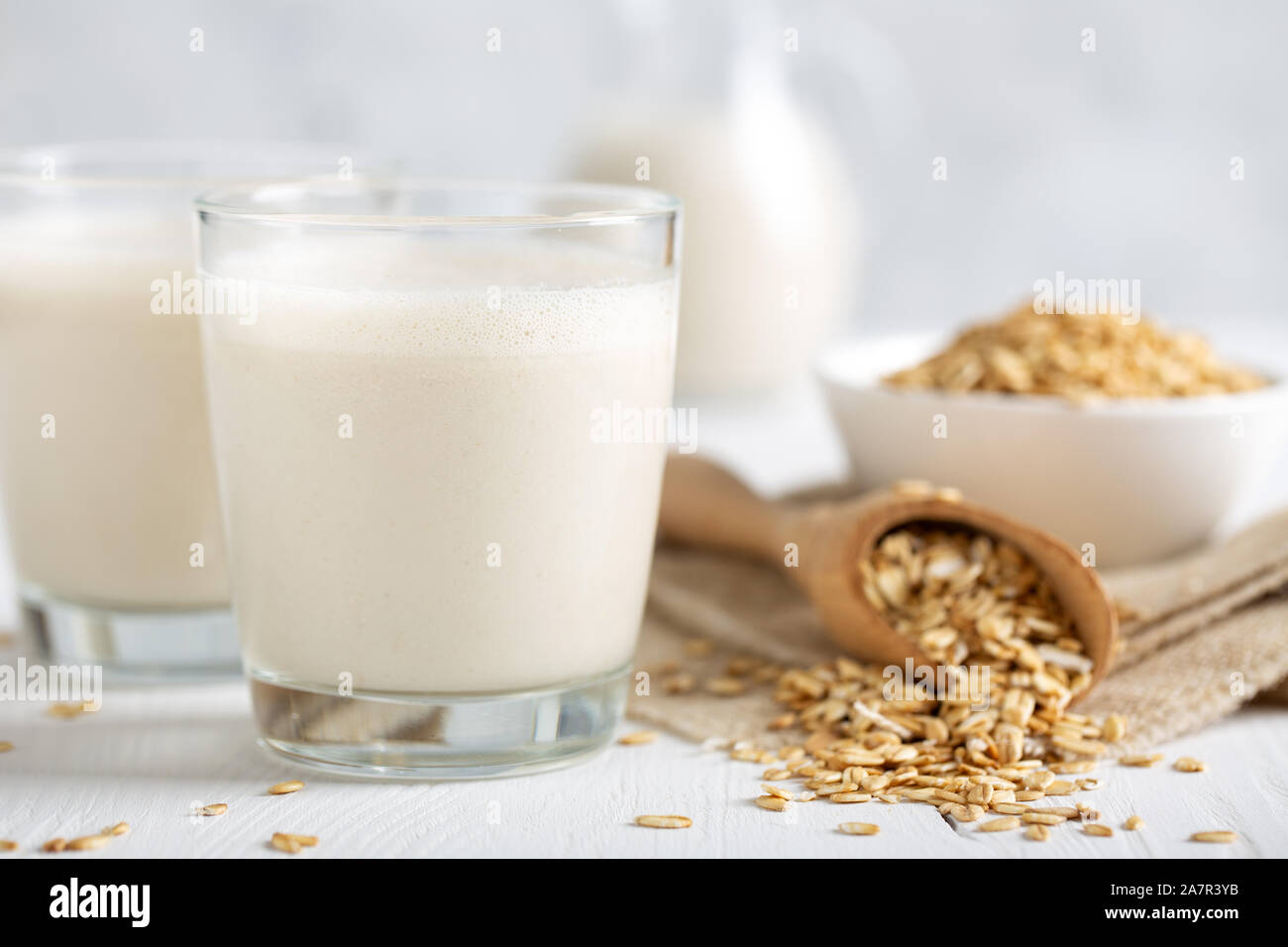 Oat milk. Healthy vegan nondairy organic drink with flakes Stock Photo