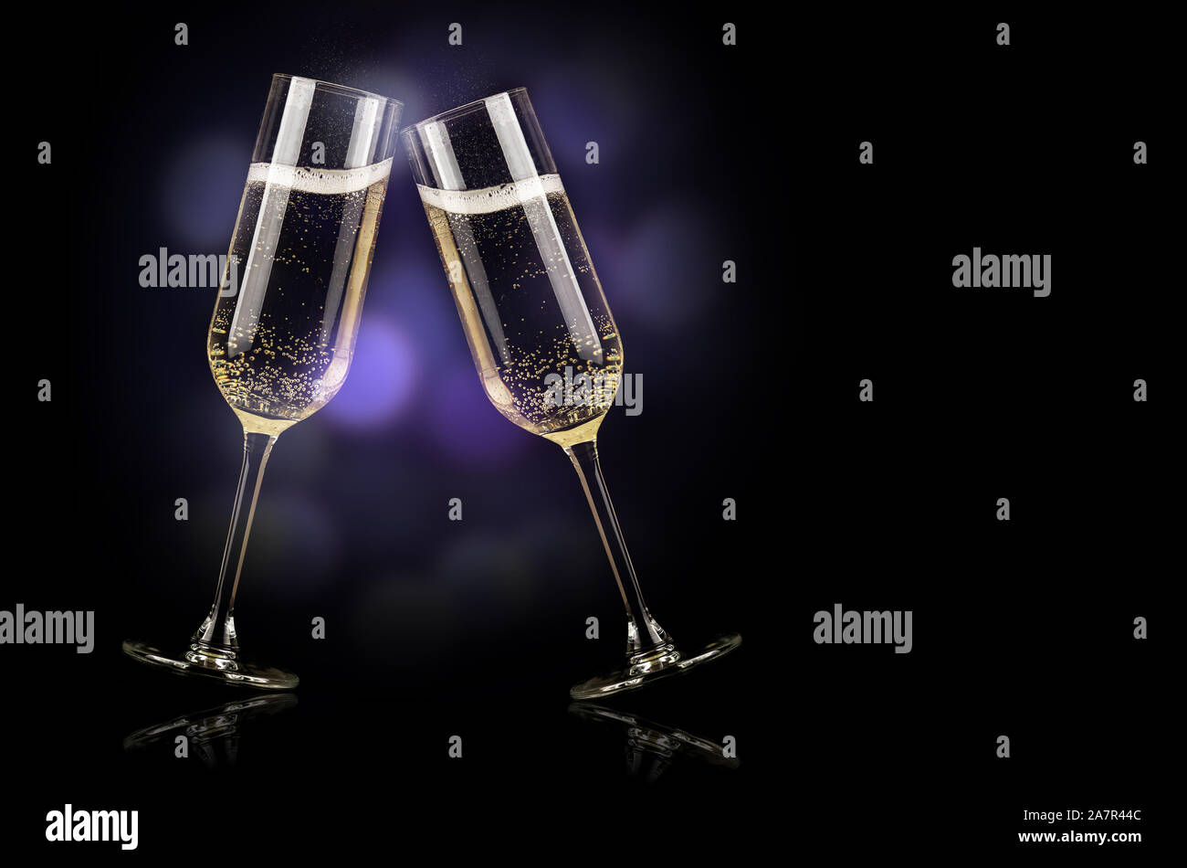 champagne glasses with splash on black background new year