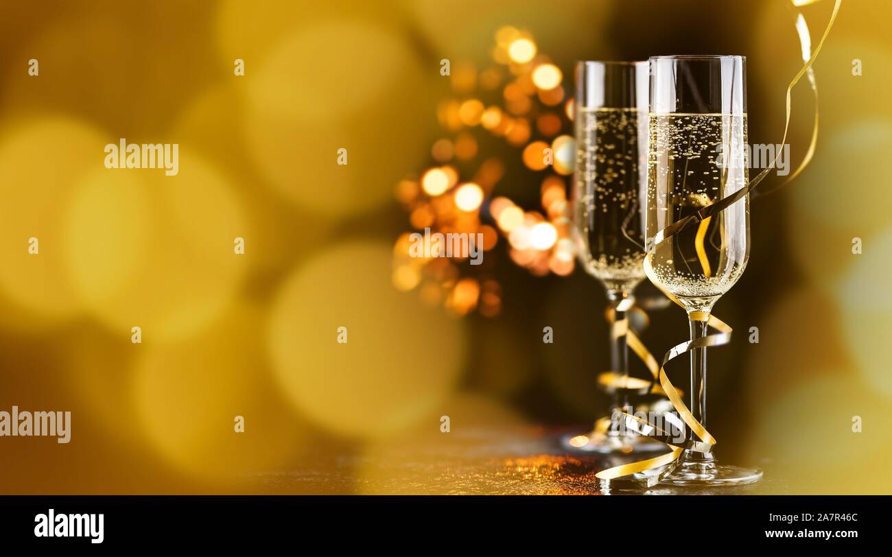 champagne glasses with golden ribbon and  sparkles - new year celebration Stock Photo