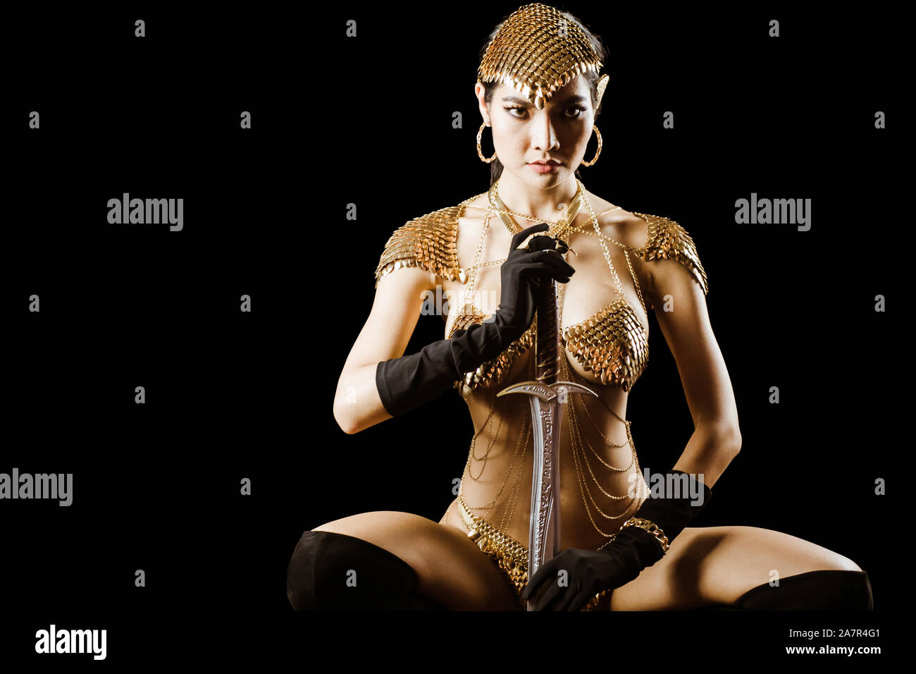 Sexy girl wearing golden queen of warrior armor fancy dress looks elegant and luxury for advertising fashion model Stock Photo Alamy