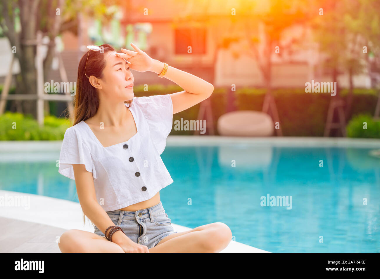 Beautiful woman with hot sunshine in summer sky for skin care and UV sun block Asian people beauty concept. Stock Photo