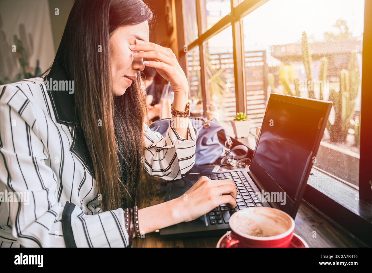 Business woman eye pain strain fatigue from computer vision syndrome. Stock Photo