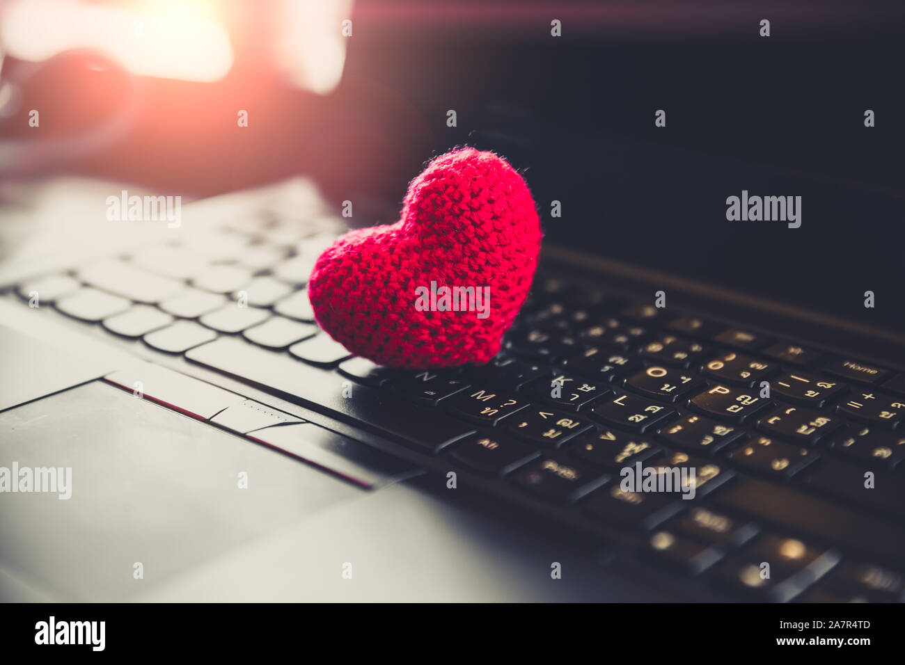 Red heart on computer laptop keyboard for love chat online dating Stock Photo