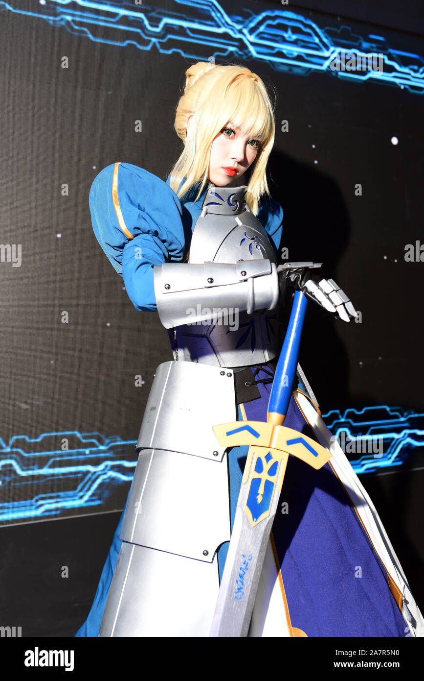 A Chinese showgirl dressed in cosplay costume featuring Saber, whose real name is Artoria Pendragon, from 'Fate/Grand Order' poses during the 17th Chi Stock Photo
