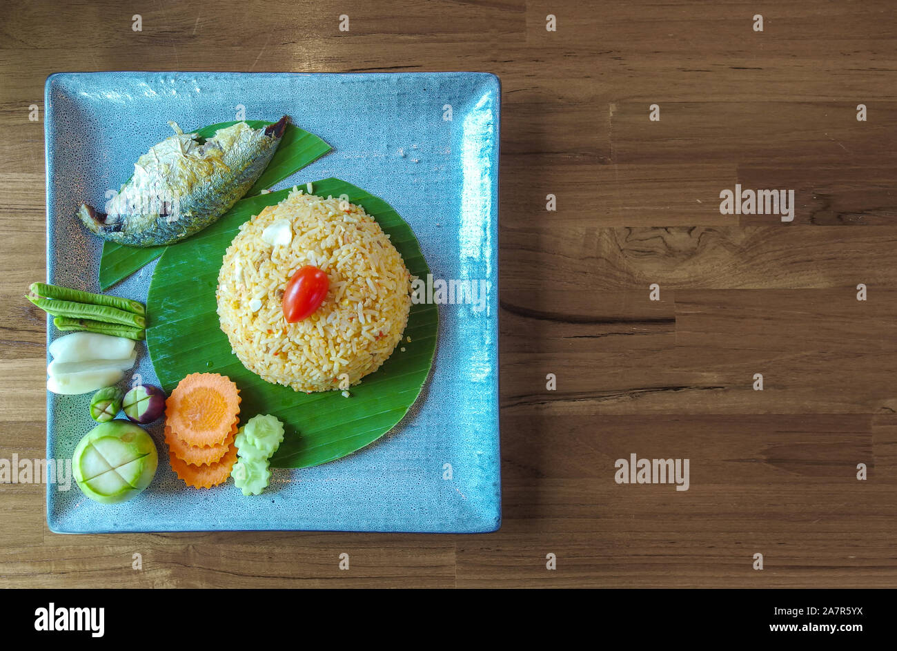 Thai cusine Fried rice with grilled Tuna fish menu dish on wood table