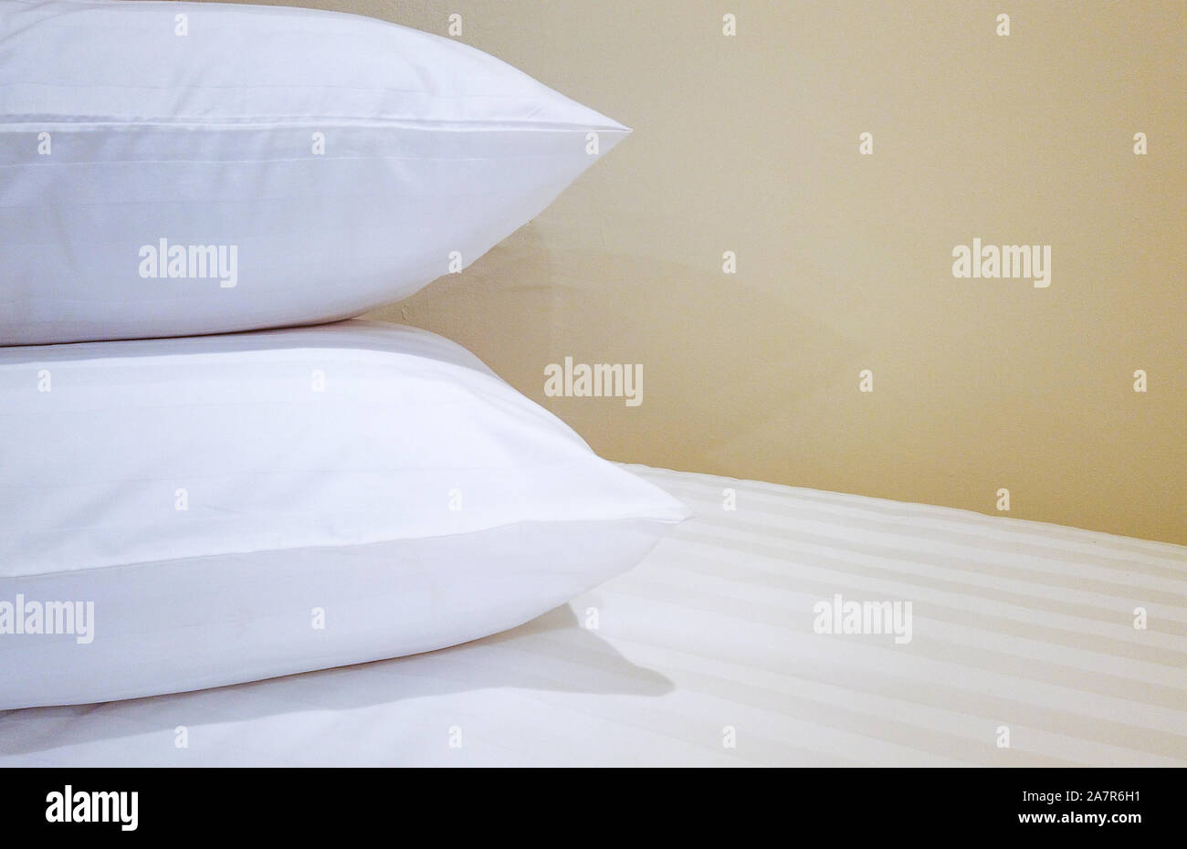 double pillows on bed which preparing for guest background. Stock Photo