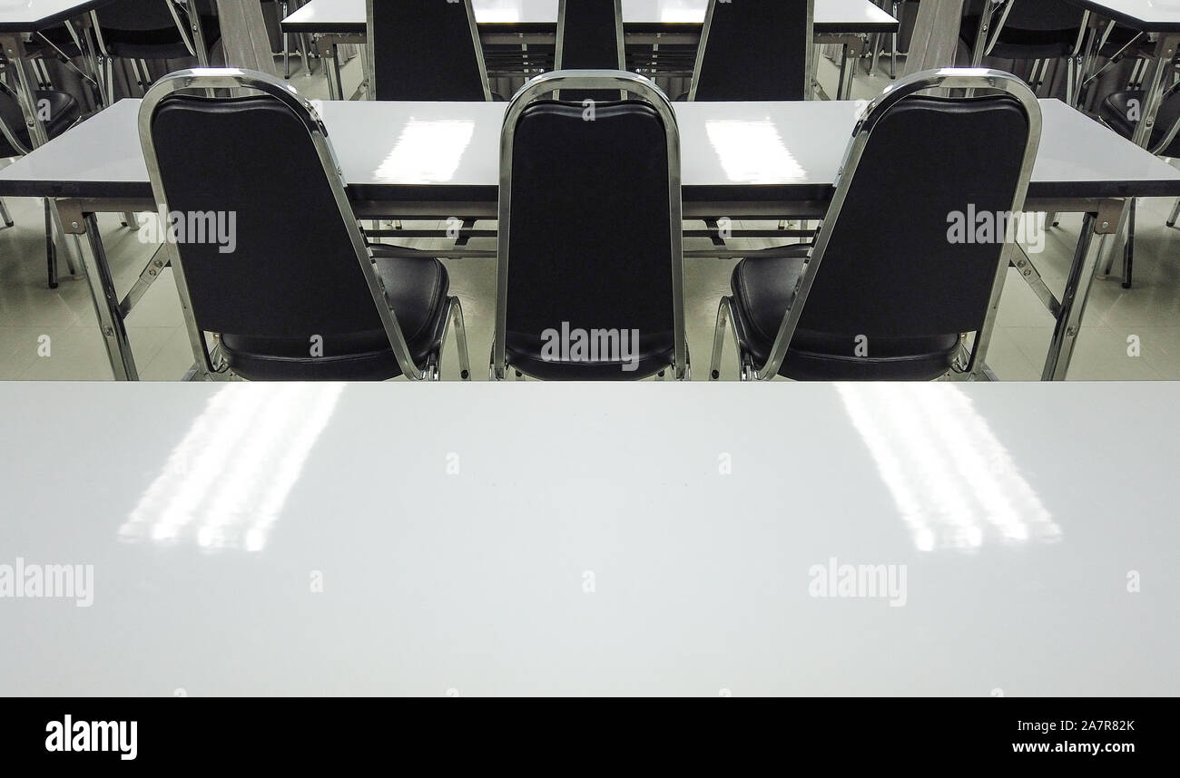 Empty nobody chairs and desks in classroom background. Stock Photo