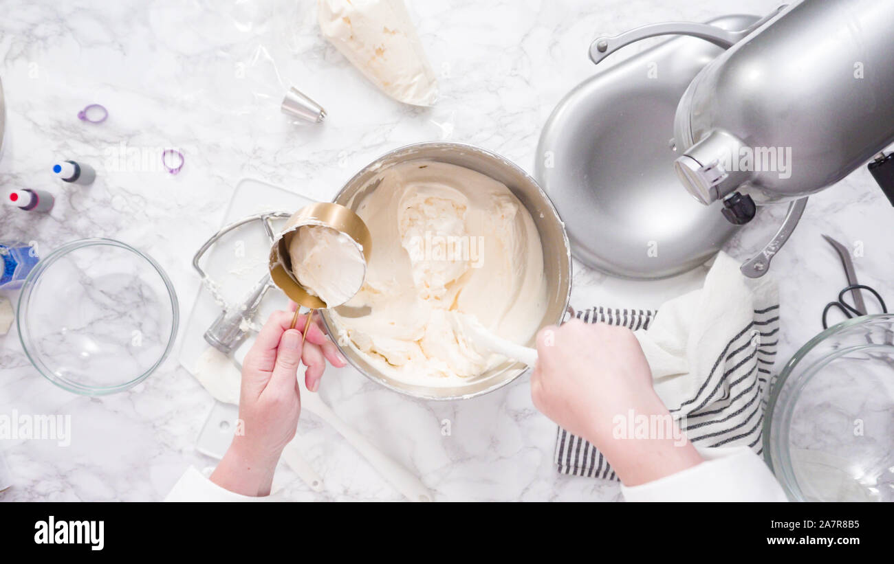 Mixing ingredients in standing kitchen mixer to make buttercream