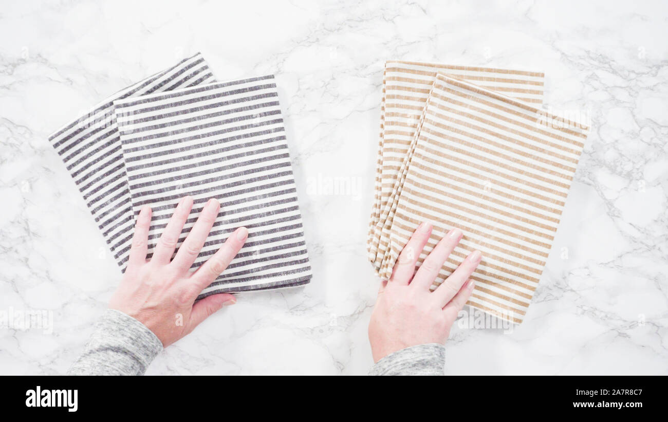 Flat lay. Folding kitchen towels on a marble countertop Stock Photo Alamy
