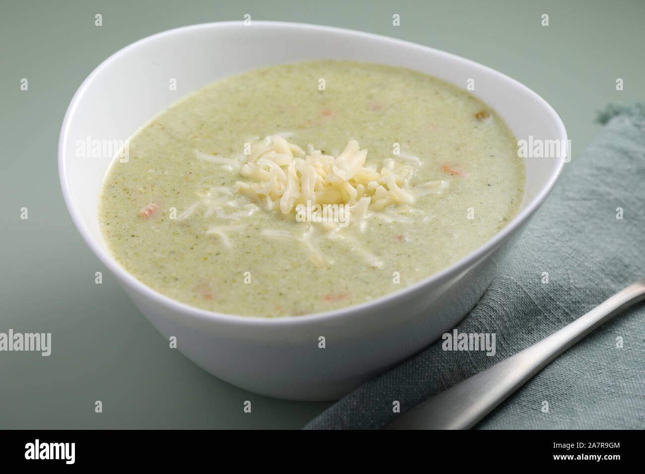 Broccoli cream soup with grated mozzarella cheese in a bowl closeup Stock Photo