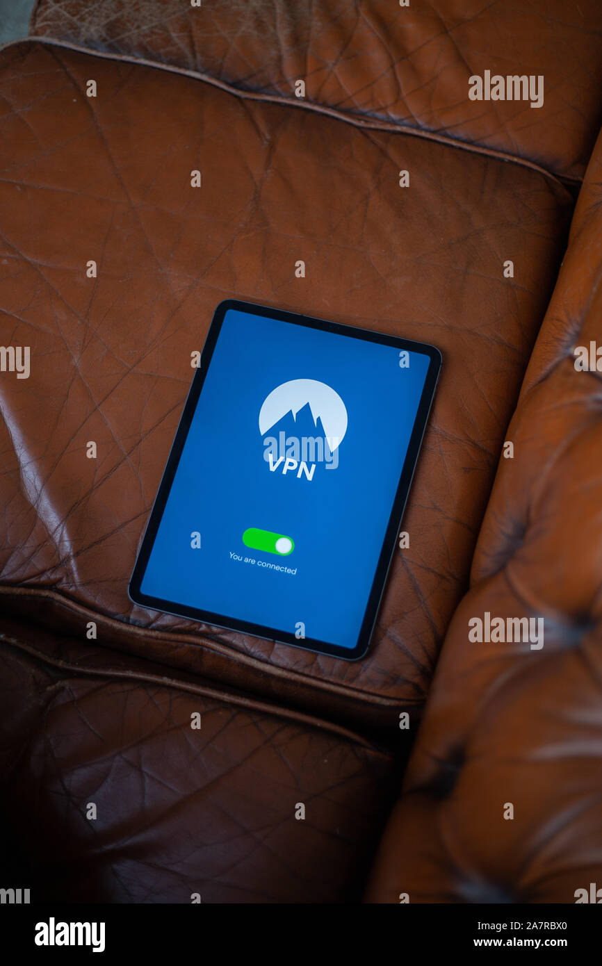 Tablet with VPN application on is laying down on the sofa Stock Photo