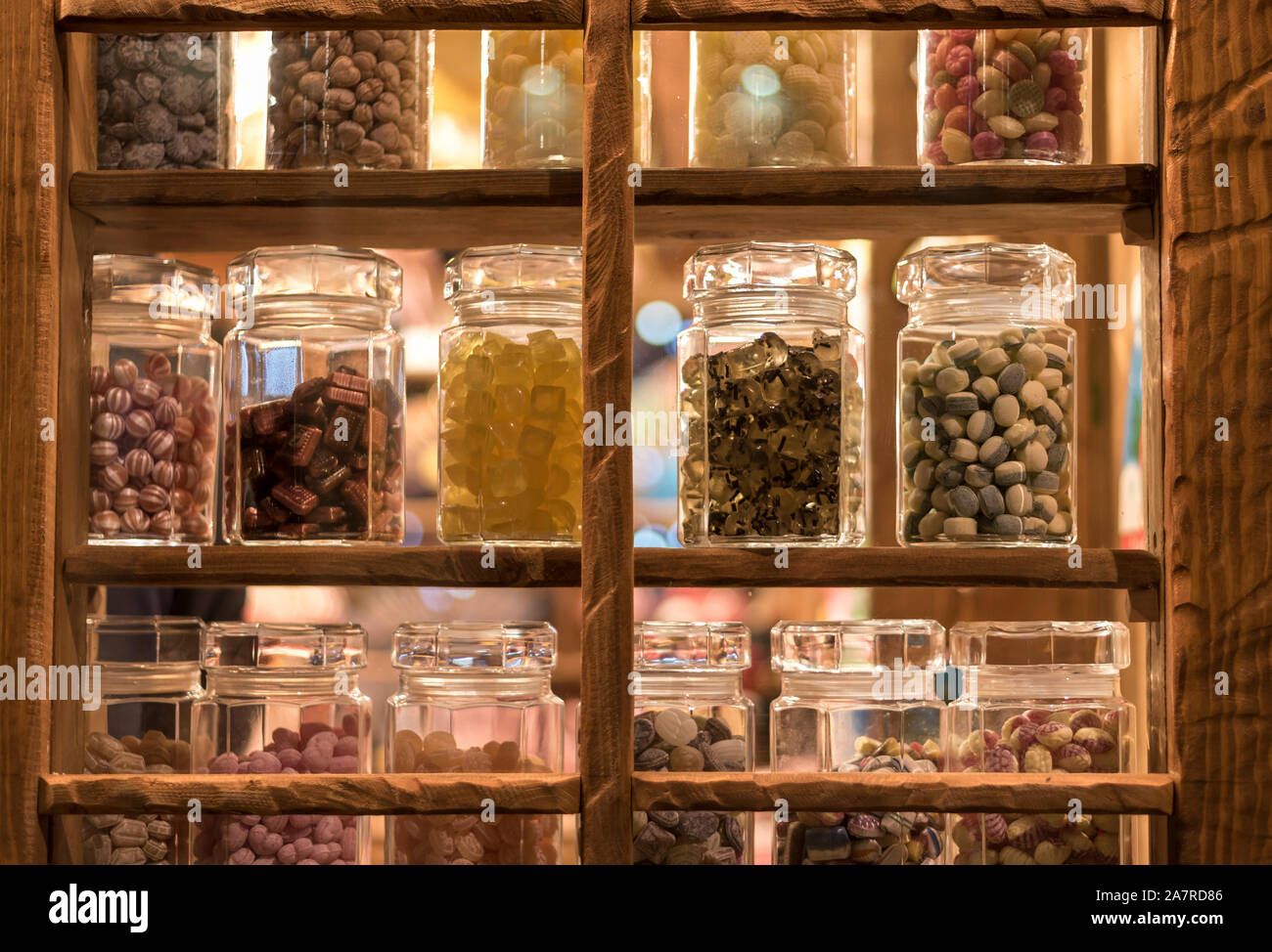 Lots of sweets, in a traditional sweet shop window, at night Stock Photo