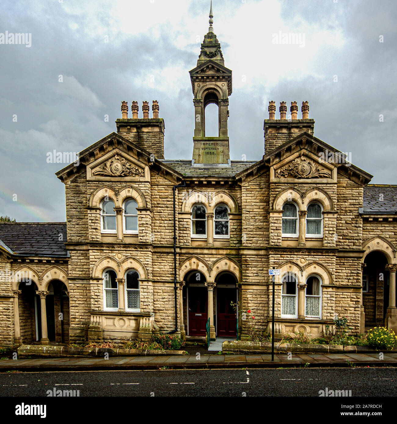 Titus Salt built his alms houses in a variety of sizes, these landmark features are intended for families and include his Latin motto and a datestone Stock Photo