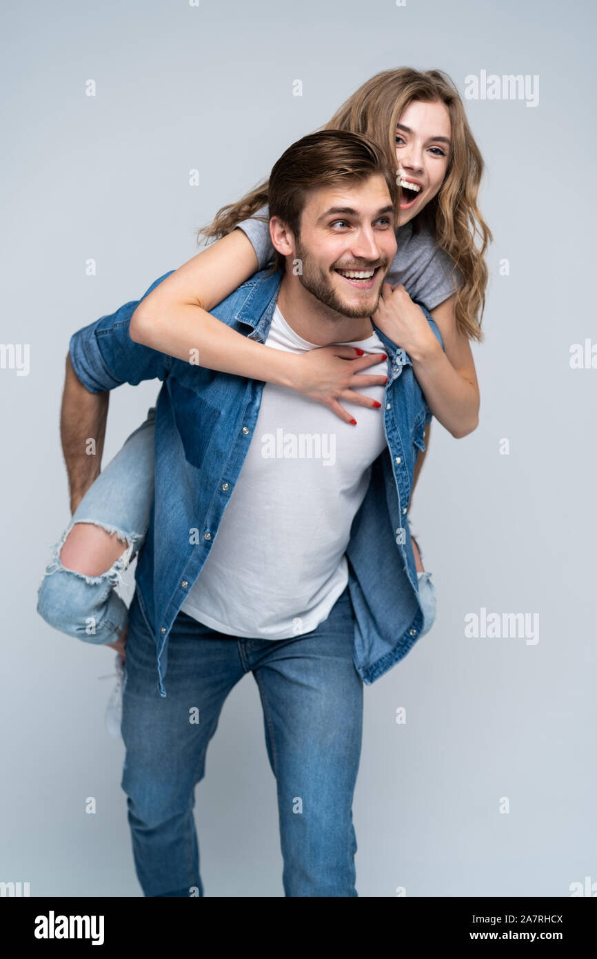 Cute portrait of couple. Guy rolls a girl on his back Stock Photo