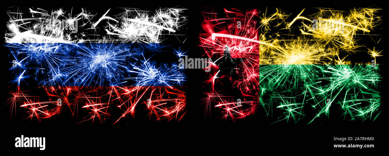 Russia, Russian vs Guinea Bissau New Year celebration sparkling fireworks flags concept background. Combination of two states flags. Stock Photo