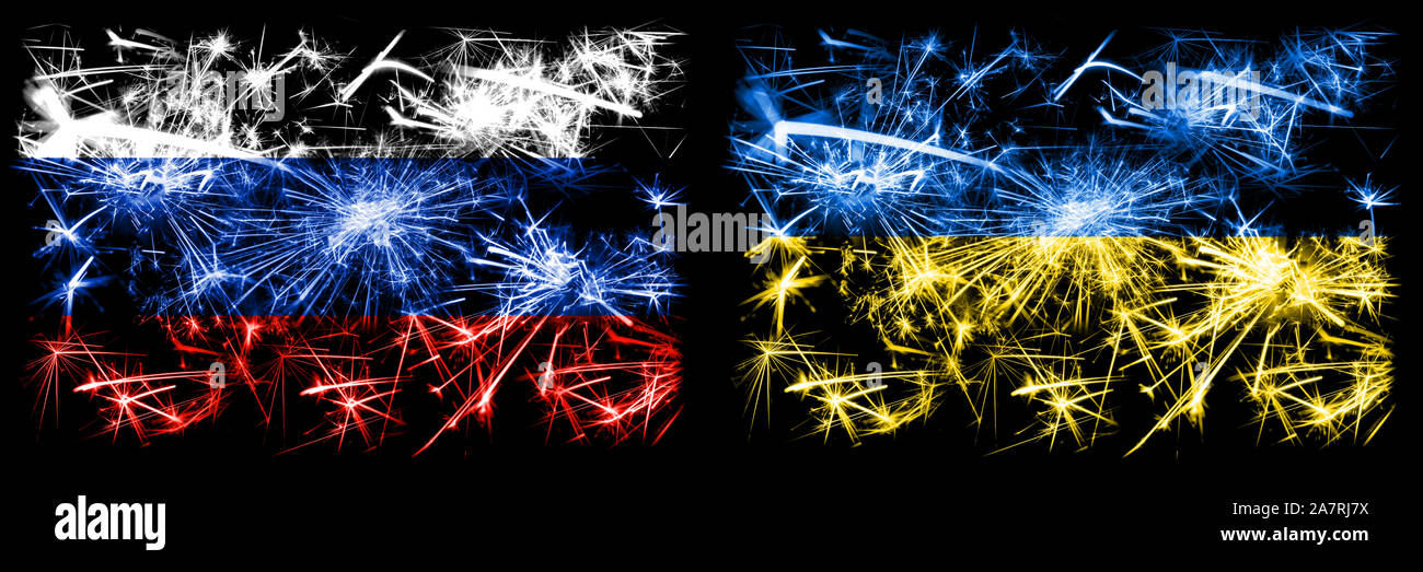 Russia, Russian vs Ukraine, Ukrainian New Year celebration sparkling fireworks flags concept background. Combination of two states flags. Stock Photo