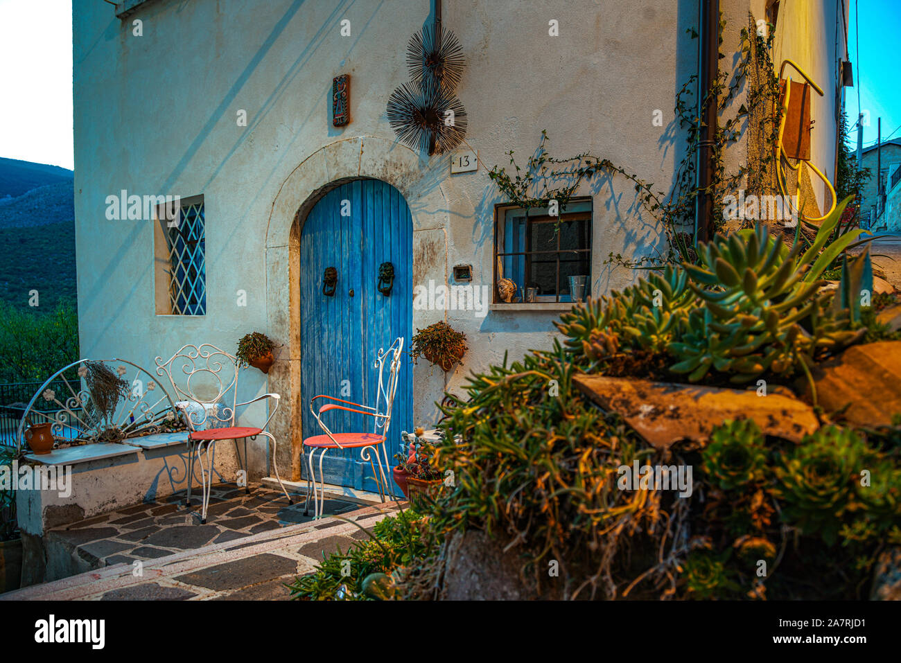two pink chairs and one bleu door. Abruzzo Region, Italy, Europe Stock Photo
