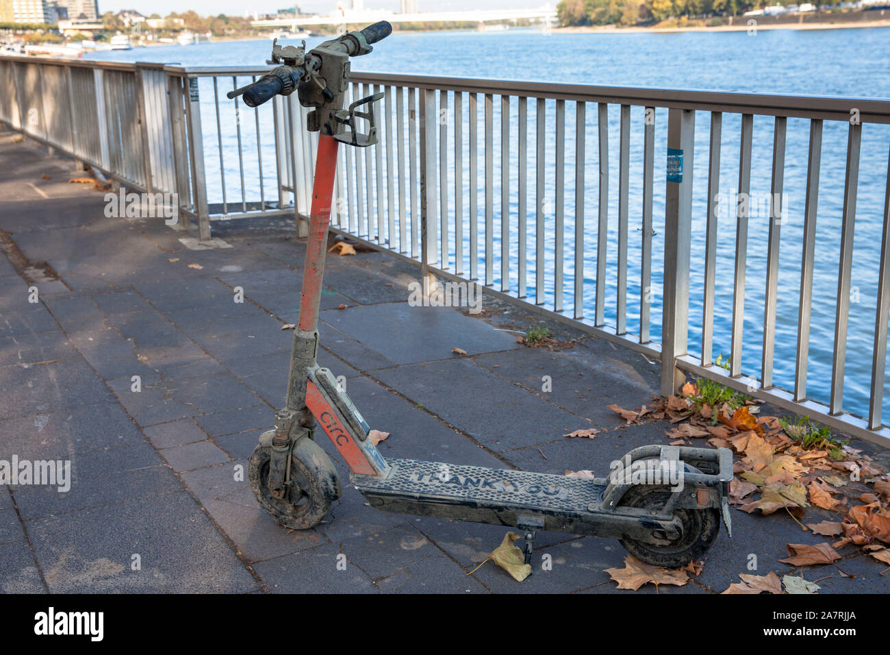 a dirty Circ electric scooter recovered from the Rhine stands on the banks of the Rhine, Cologne, Germany.  aus dem Rhein geborgener Circ Elektroscoot Stock Photo
