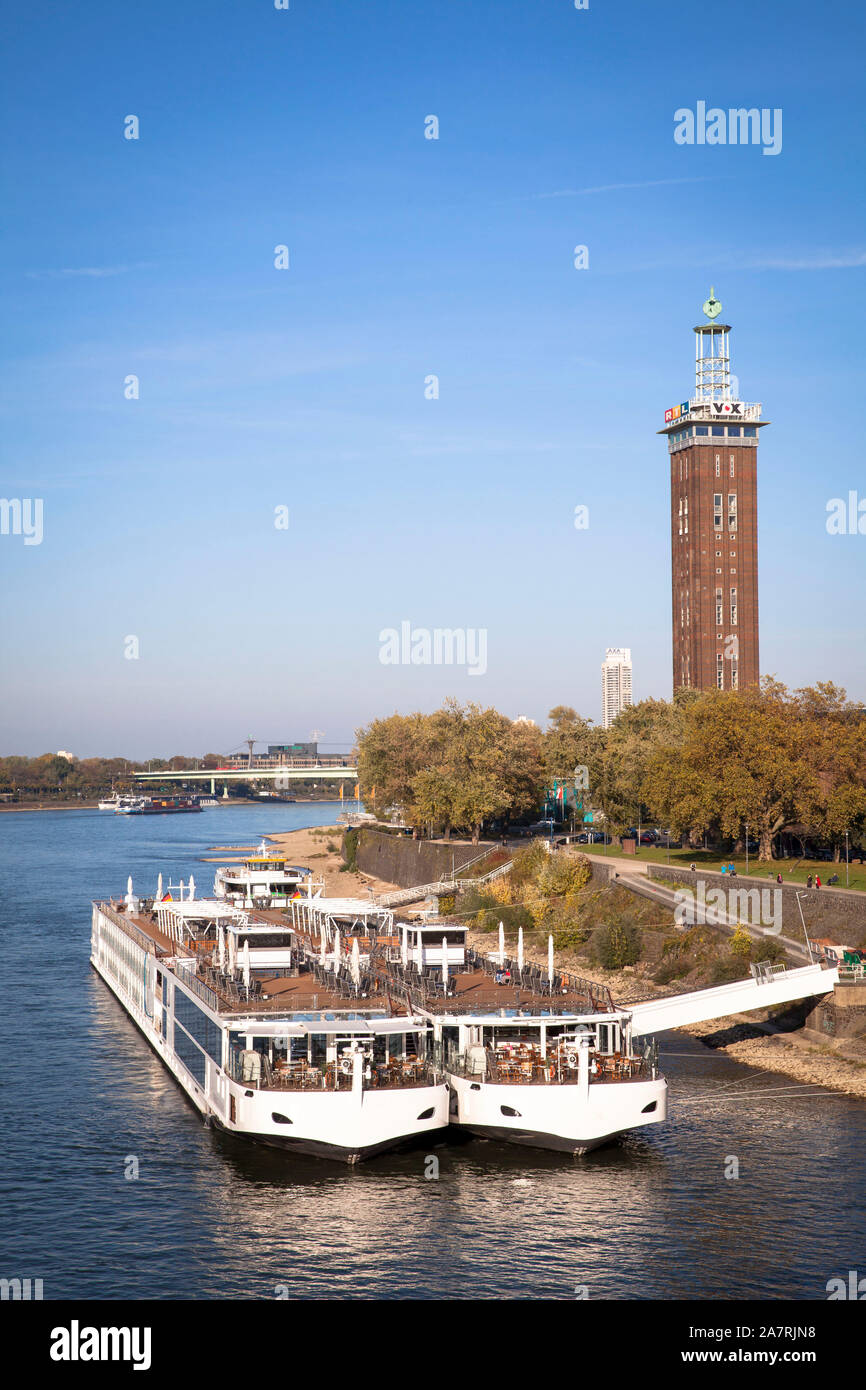 view across the river Rhine to the old tower of the former exhibition center in the district Deutz, cruise ships, Cologne, Germany.  Blick zum alten M Stock Photo