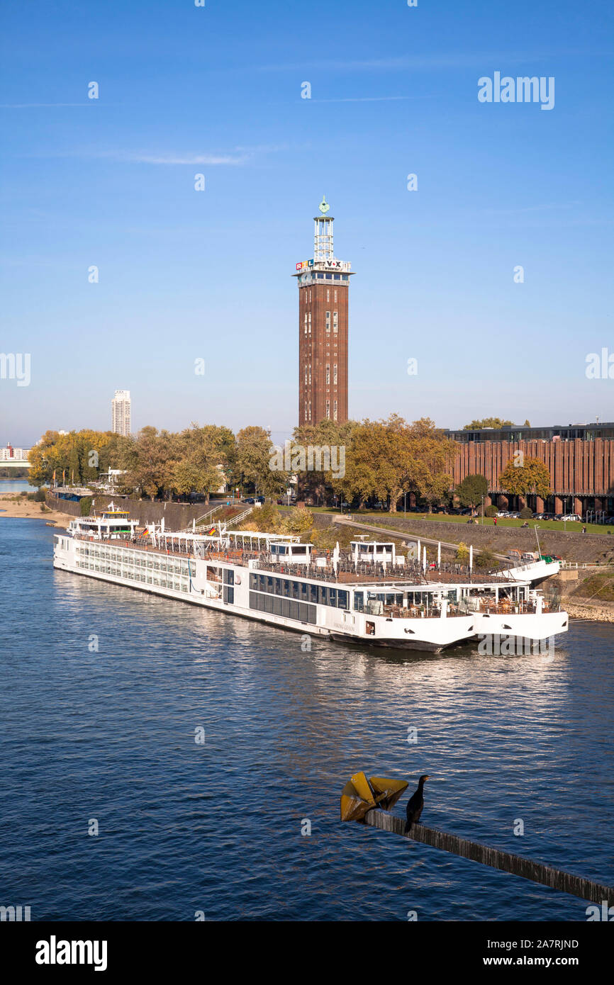 view across the river Rhine to the old tower of the former exhibition center in the district Deutz, cruise ships, Cologne, Germany.  Blick zum alten M Stock Photo