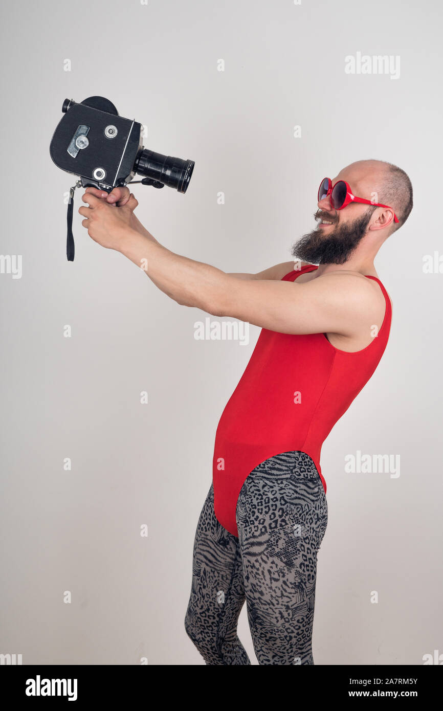 Crazy guy in funny clothes shoots himself on an old video camera Stock Photo