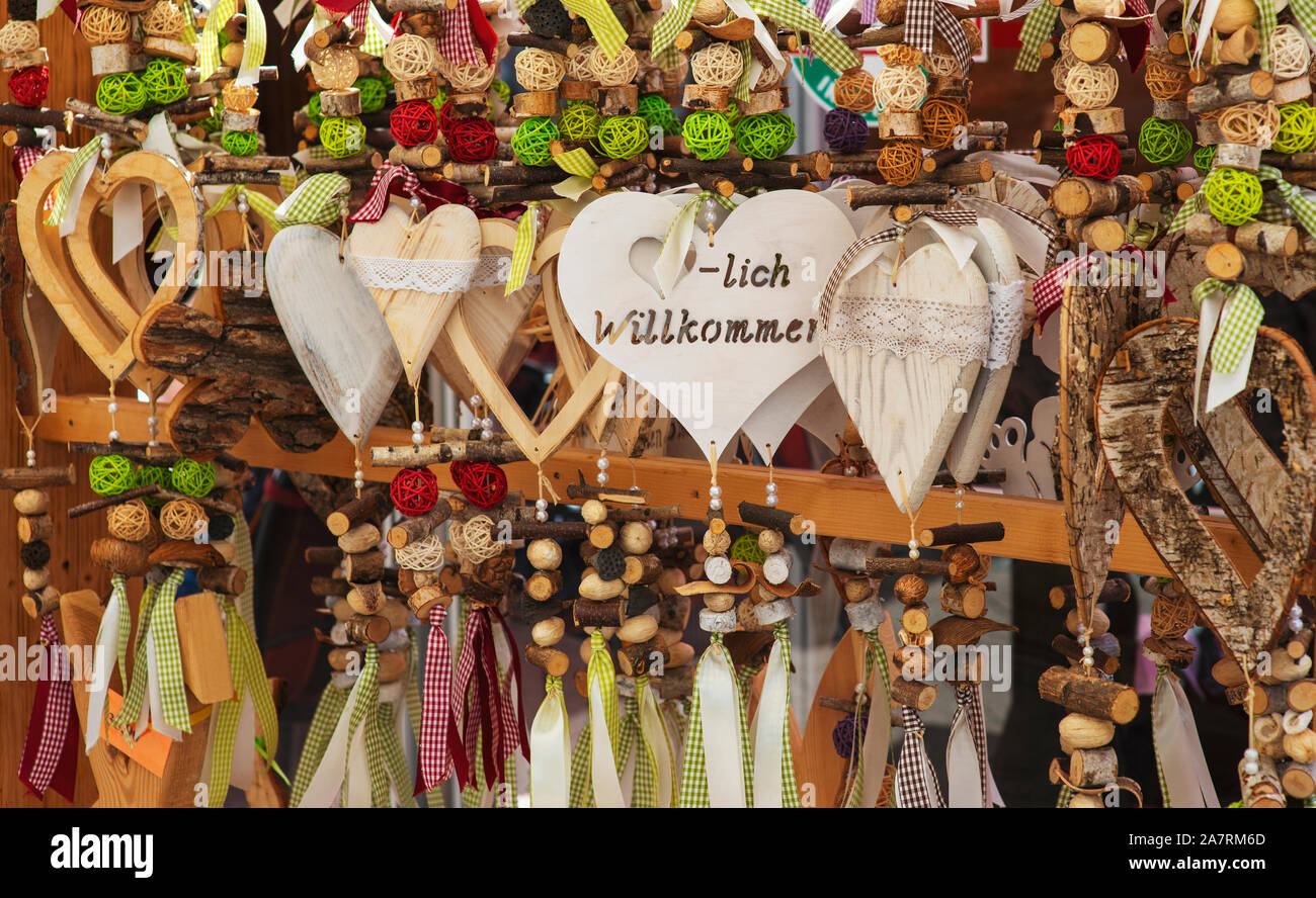 Traditional german souvenirs in shaped of heart on market with text 'You are welcome'. Stock Photo