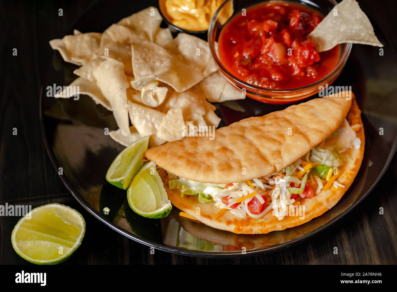 Homemade Baja Fish Tacos with Mango Salsa and Chips. Mixed mexican food ...