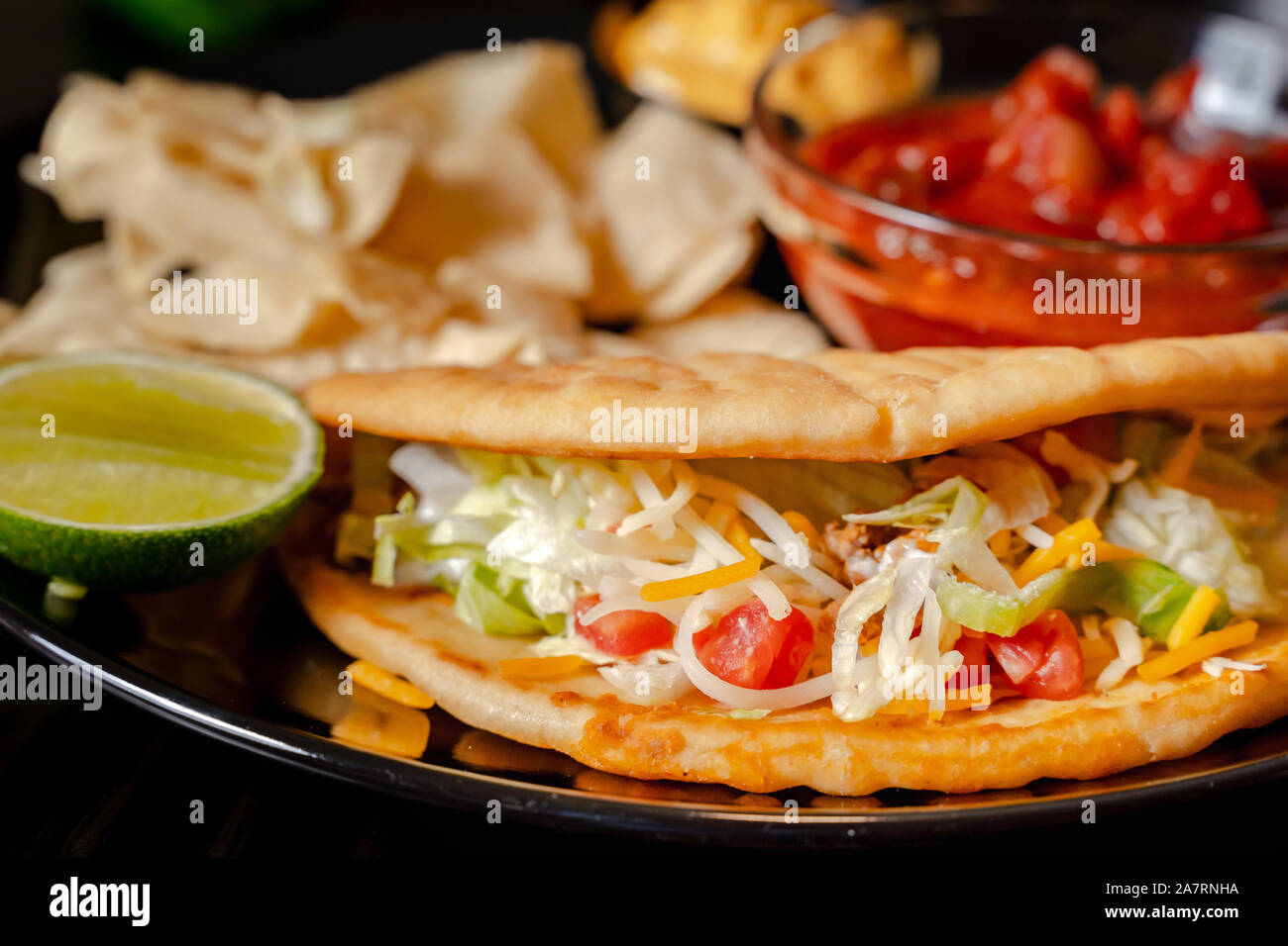 Homemade Baja Fish Tacos with Mango Salsa and Chips. Mixed mexican food ...