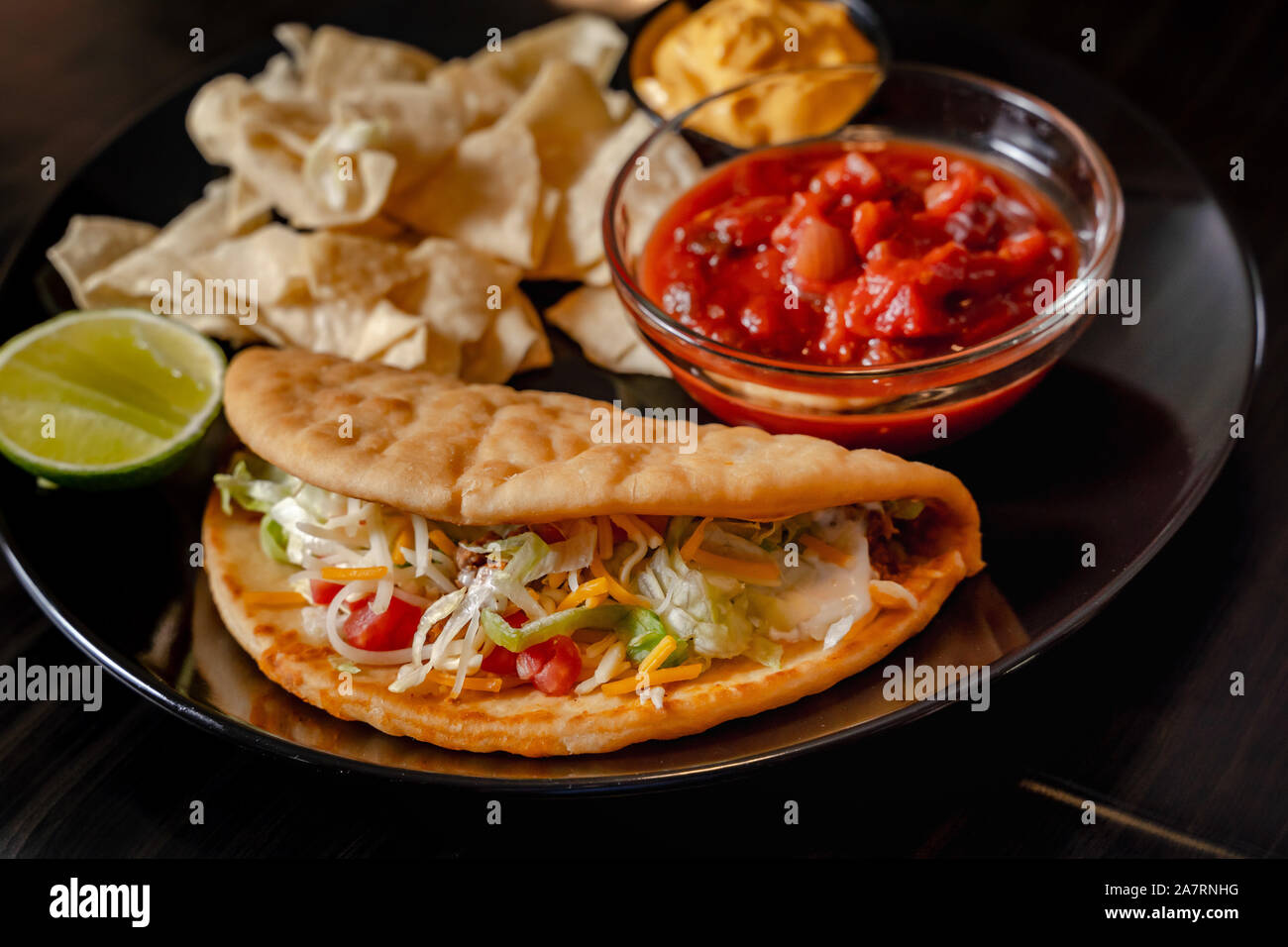 Homemade Baja Fish Tacos with Mango Salsa and Chips. Mixed mexican food ...