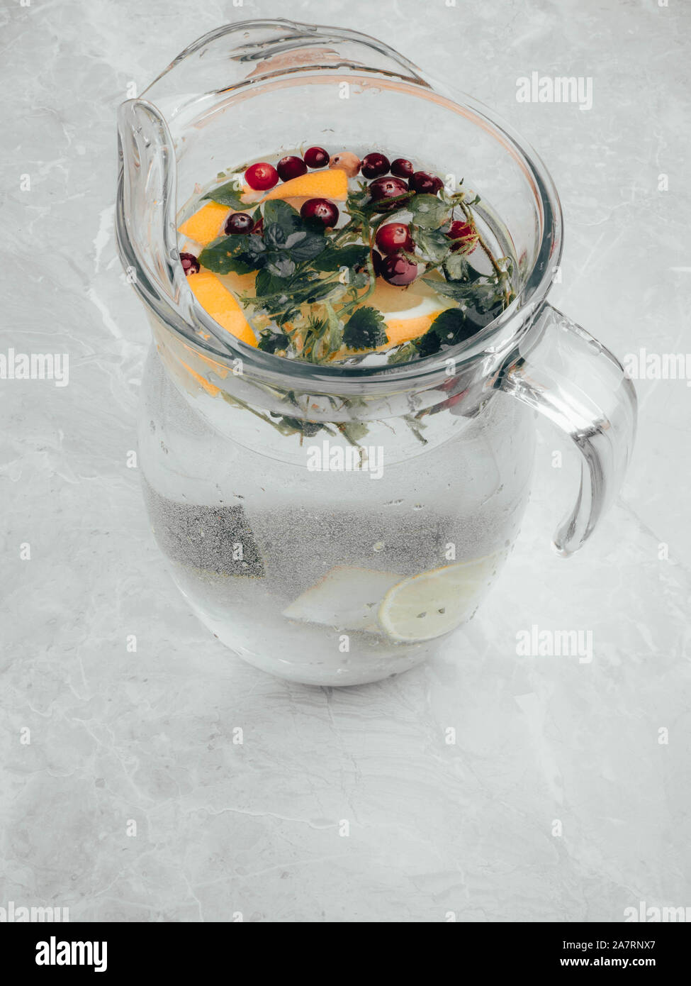 https://c8.alamy.com/comp/2A7RNX7/lemonade-pitcher-with-lemon-slices-mint-leaves-red-berries-and-ice-on-glass-jug-view-with-copy-space-2A7RNX7.jpg