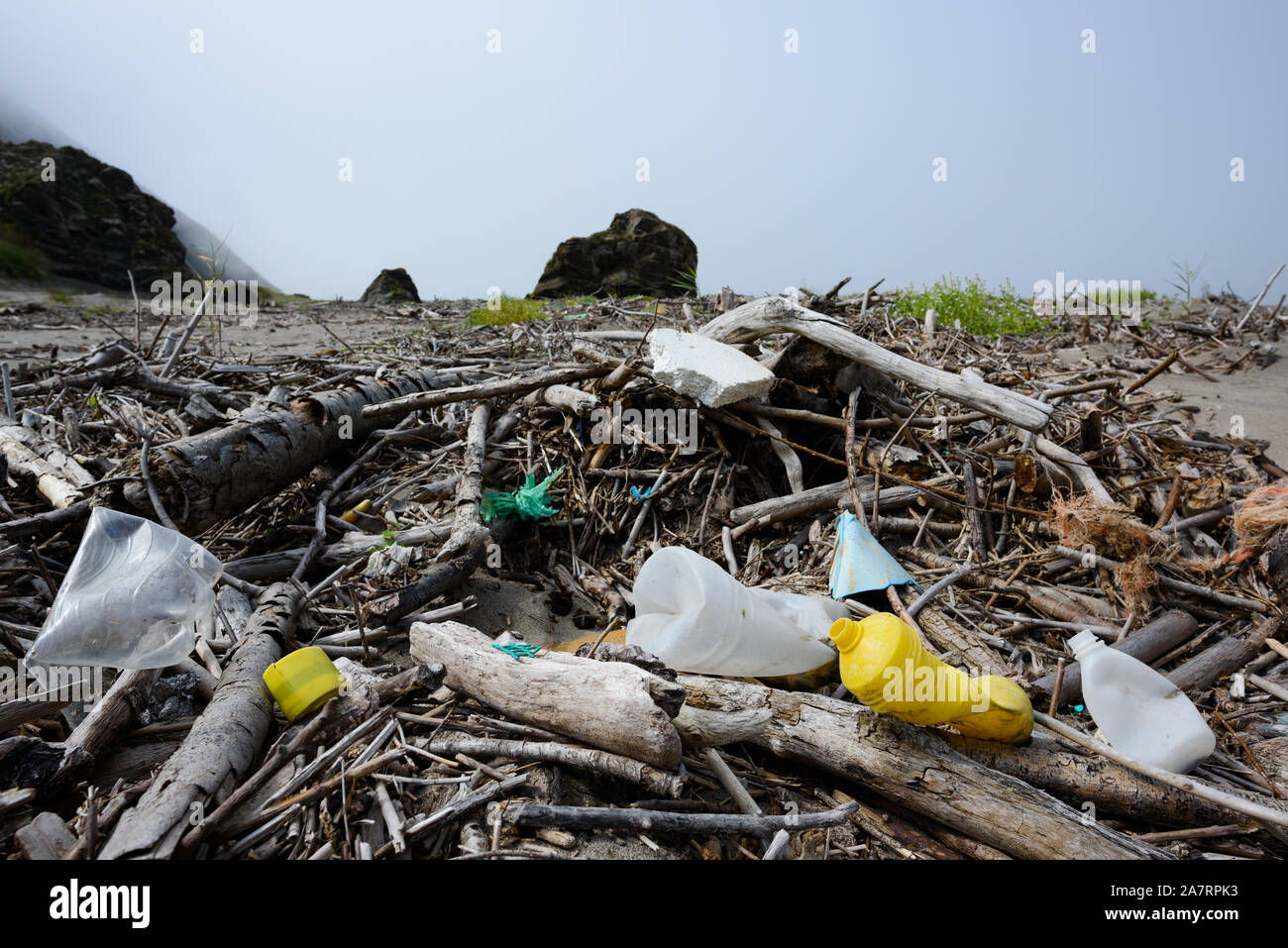 Plastic bottles and rubbish waste on ocean beach. Human caused enviroment trash pollution. Stock Photo